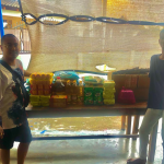 Rice donation ritual for merit making at Thai temple